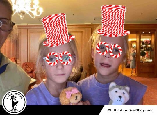 Two Little America Cheyenne guests wearing candy-striped photo filters