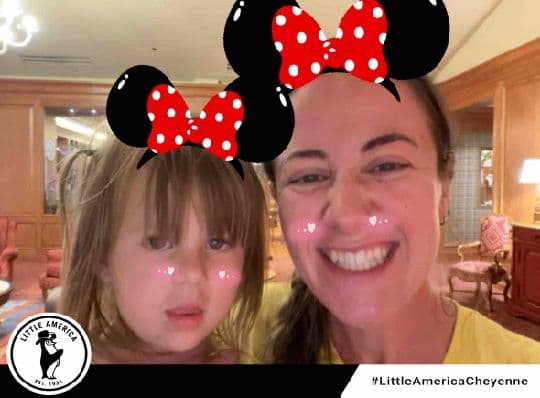 Two Little America Cheyenne guests posing with mouse-ear photo filters