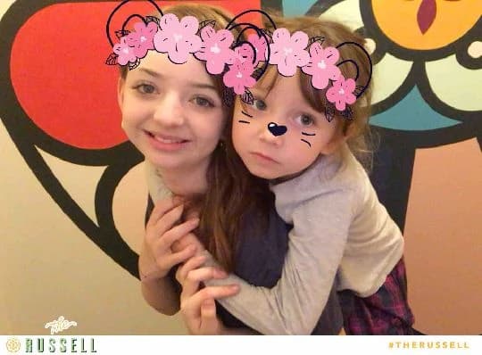 A parent and child in a branded photo at The Russell