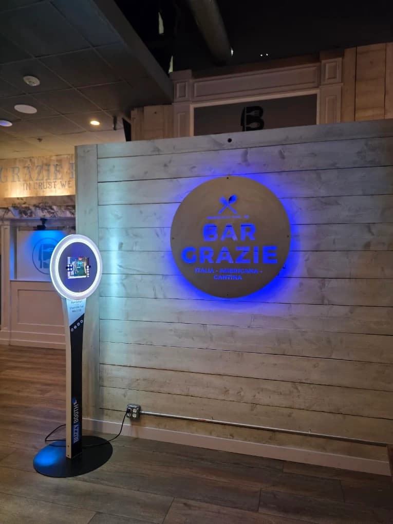 BuzzyBooth photo booth beside the Bar Grazie sign inside the restaurant