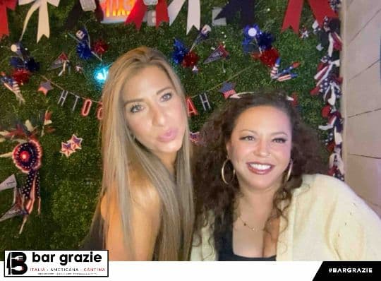 Two Bar Grazie guests smiling for a branded photo