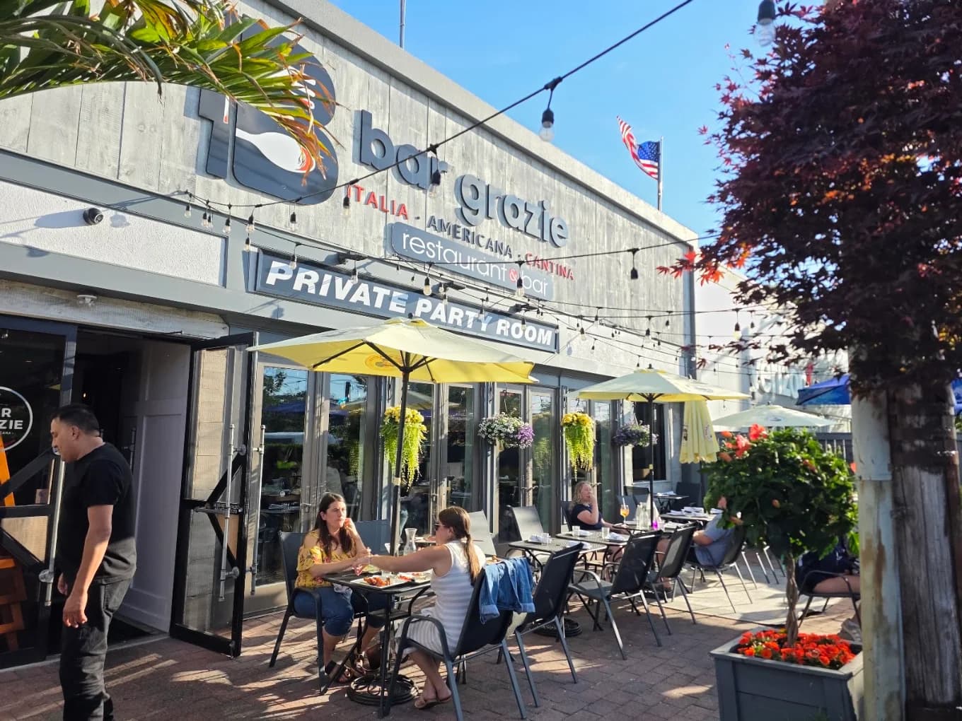 Guests dining on the patio outside Bar Grazie