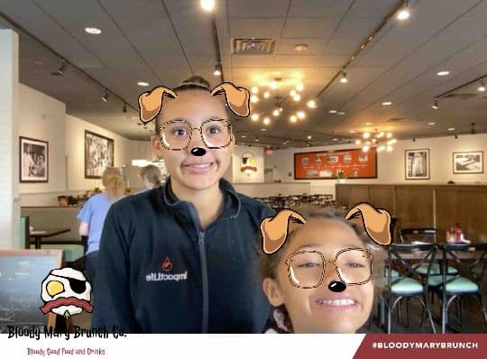 Two Bloody Mary Brunch Company guests posing with a dog filter