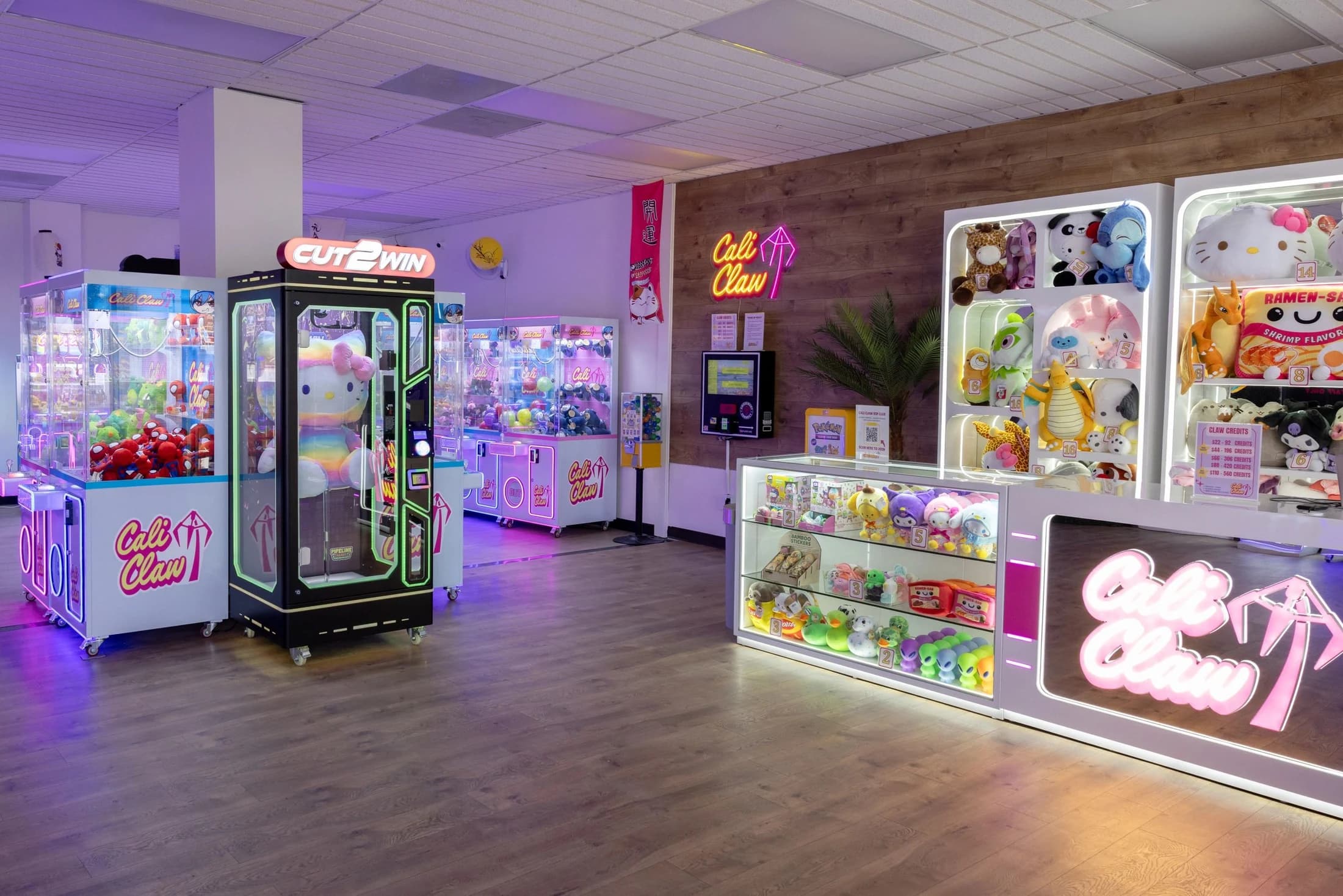 Claw machines, prizes, and the front desk inside Cali Claw Arcade