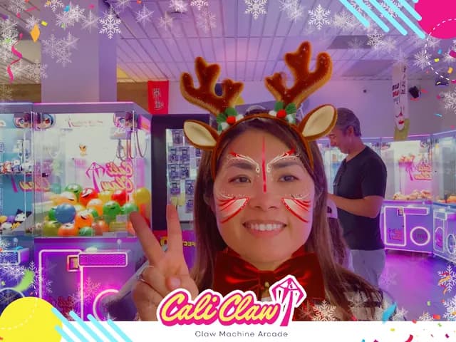Cali Claw guest smiling with a festive reindeer photo filter