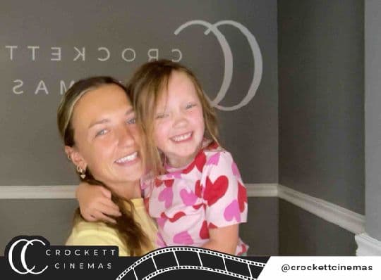 Crockett Cinemas guest holding a child in a branded photo