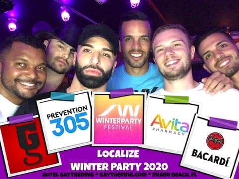 Friends posing in a branded Hotel Gaythering winter party frame