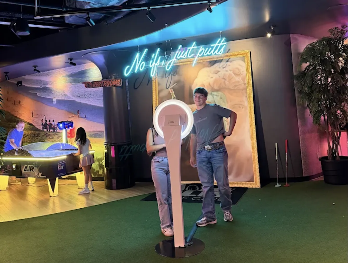 Guests using BuzzyBooth at a Holey Moley Golf Club venue