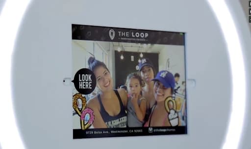 A family creating a branded photo at The Loop