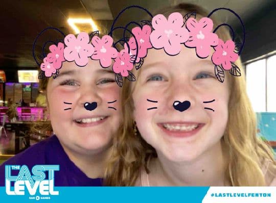 Two guests with a floral photo filter at Last Level Fenton