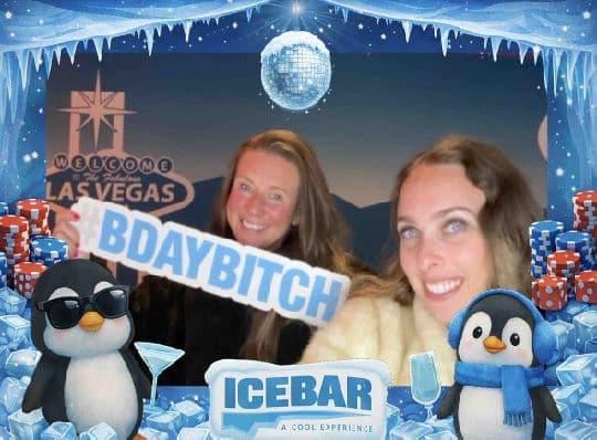 Two Ice Bar guests celebrating a birthday in a branded photo