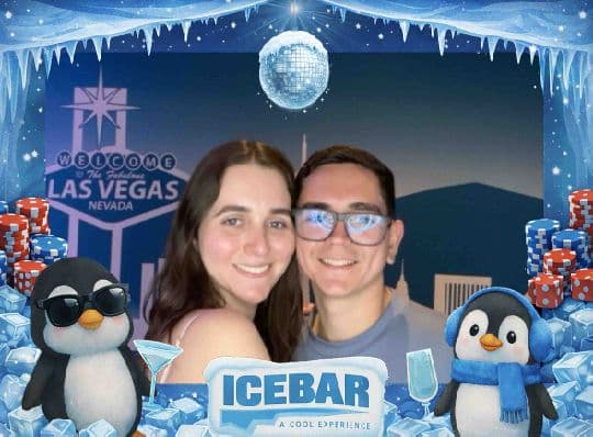 Two Ice Bar guests posing together in a branded photo
