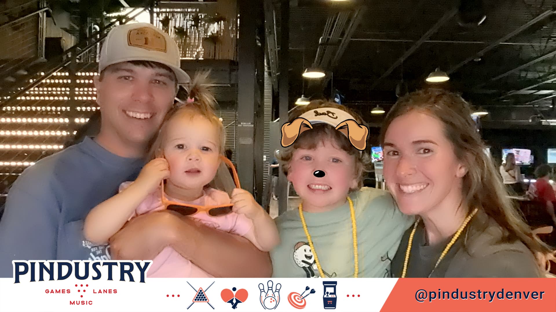 Family posing together in a branded Pindustry BuzzyBooth photo