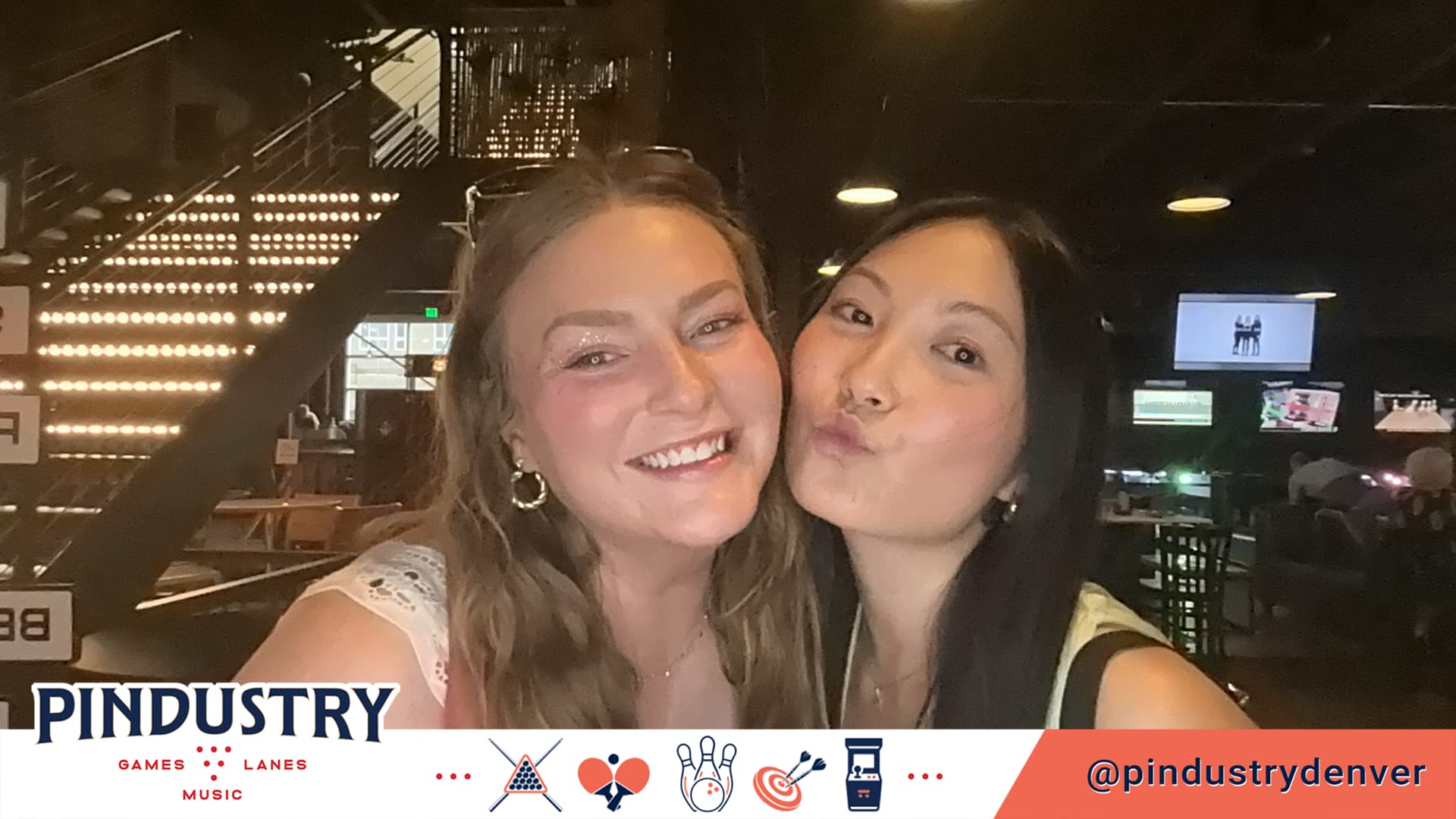 Two friends posing in a branded Pindustry BuzzyBooth photo
