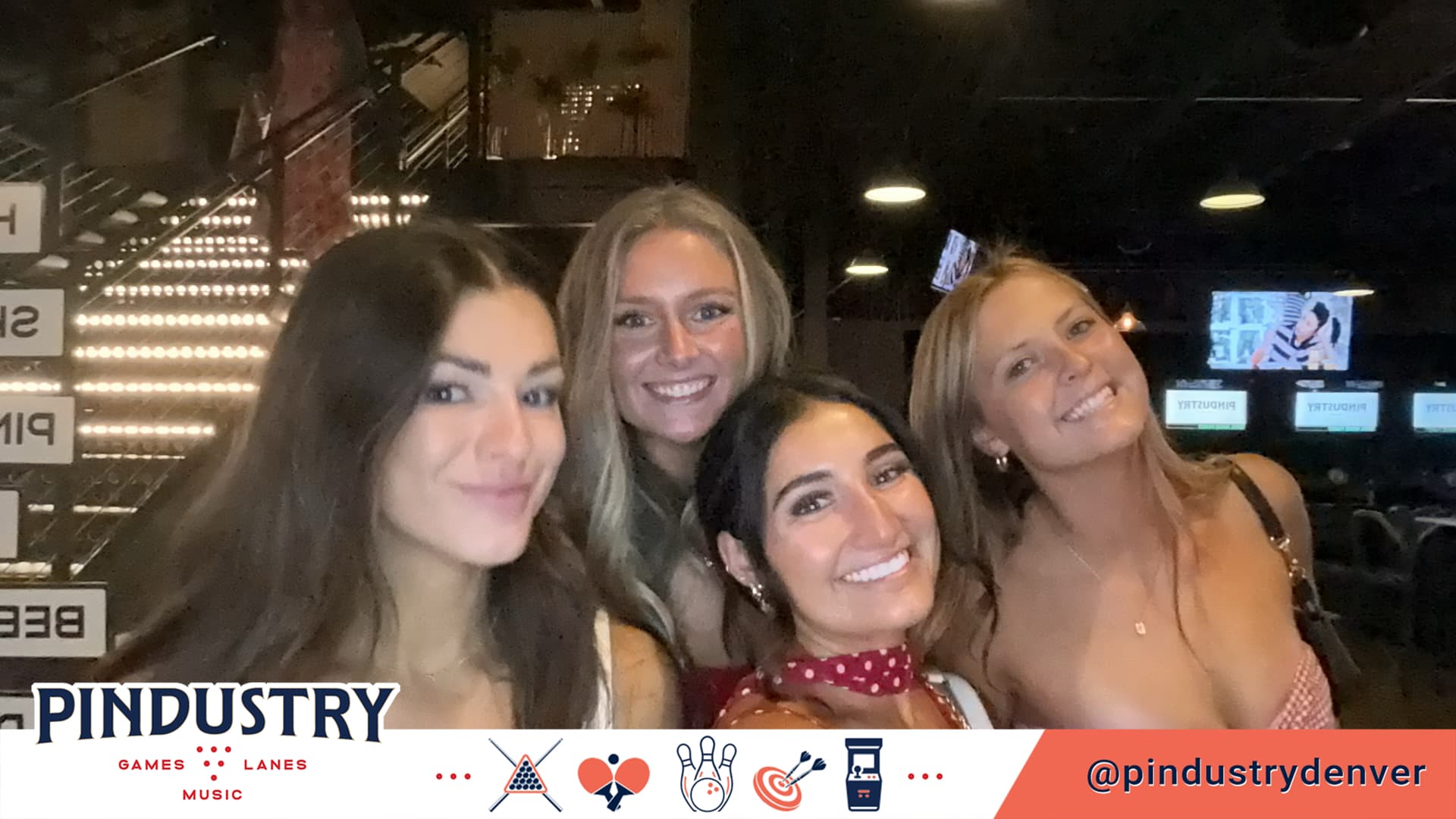 Four friends posing in a branded Pindustry BuzzyBooth photo