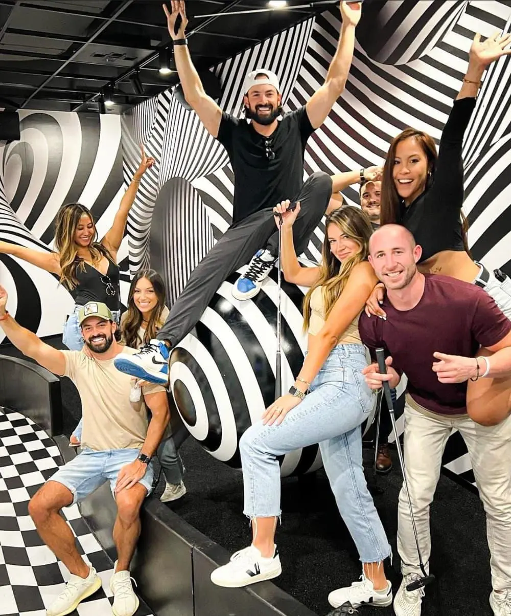 Guests posing together at a Puttery mini golf venue