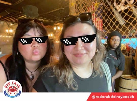 Two Red Crab guests posing with a pixel sunglasses photo filter