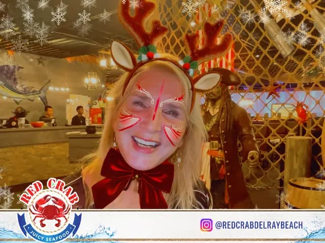 Red Crab guest smiling with a festive reindeer photo filter