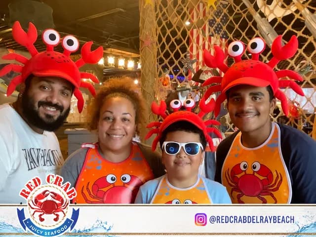 Red Crab guests posing together with playful crab hats