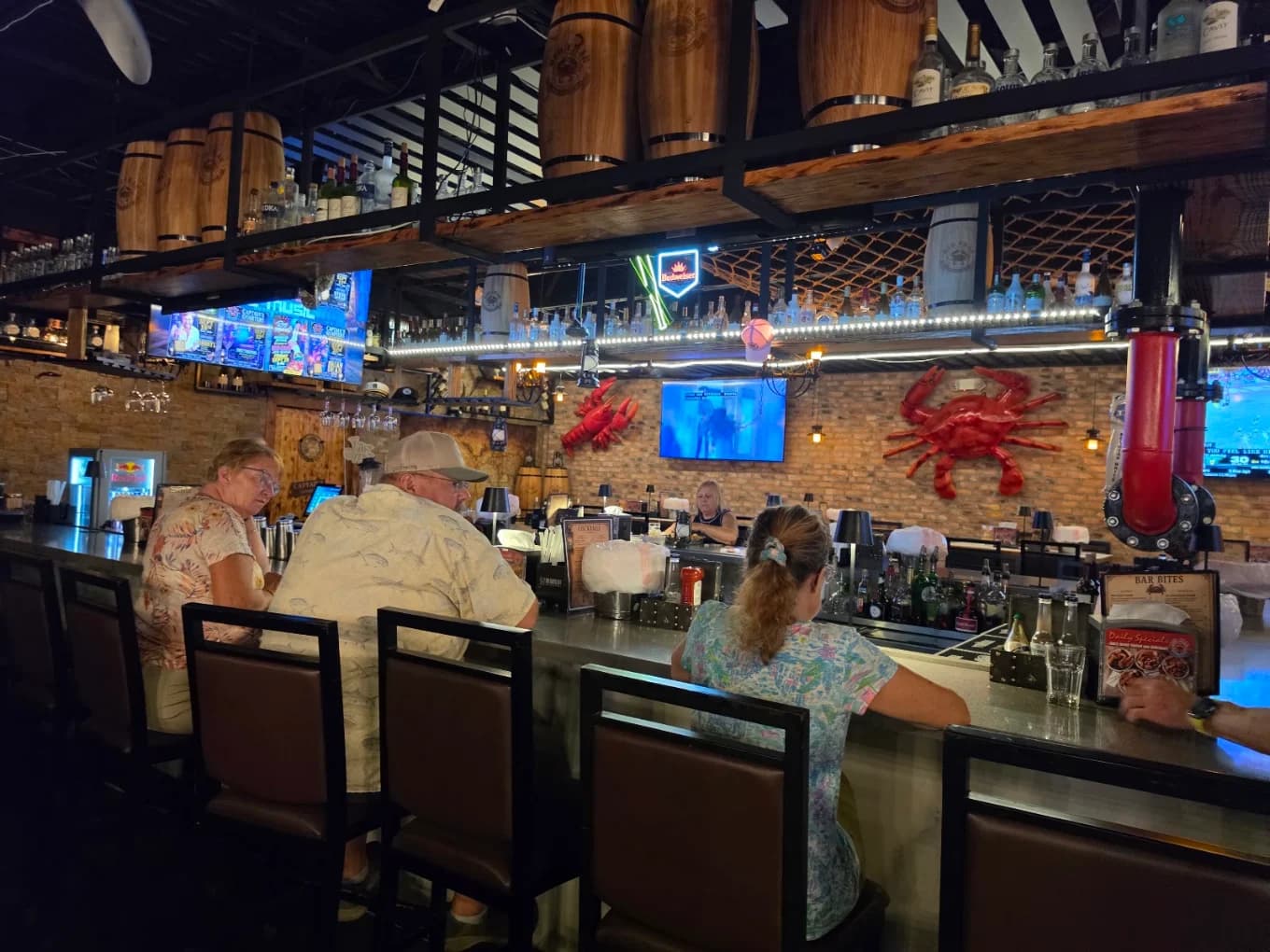 Guests seated at the bar inside Red Crab Delray Beach