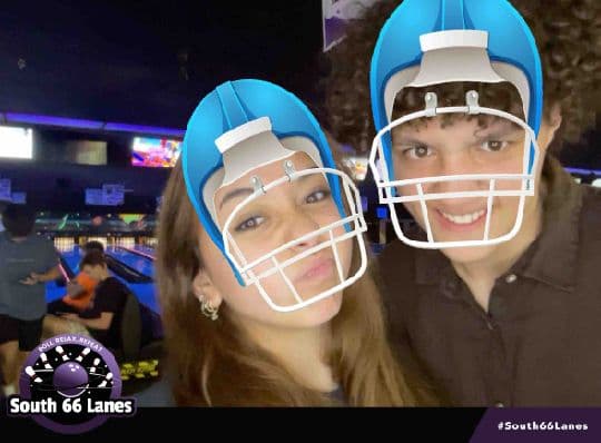 Two South 66 Lanes guests posing with football helmet filters