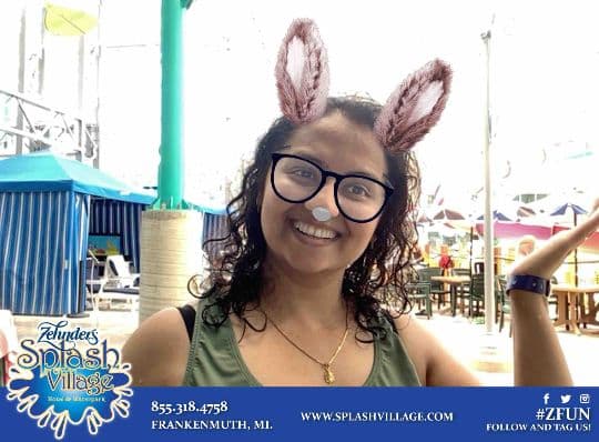 Splash Village guest smiling with a bunny ears photo filter