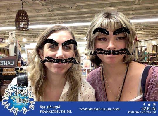Two Zehnder’s guests posing with drawn eyebrow and moustache filters