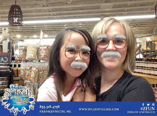 Two Zehnder’s guests posing with grey moustache photo filters