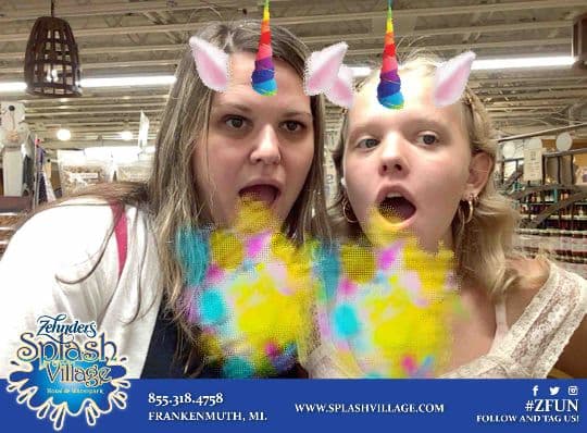Two Zehnder’s guests posing with colorful unicorn filters